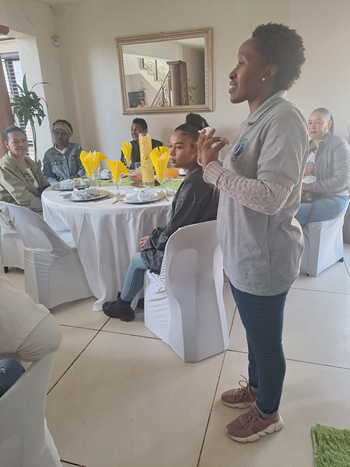 A woman speaking while others listen at the gathering
